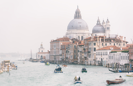 Looking out across the busy Grand Canal in Venice, with the majestically-domed Santa Maria della Salute Basilica in the background.