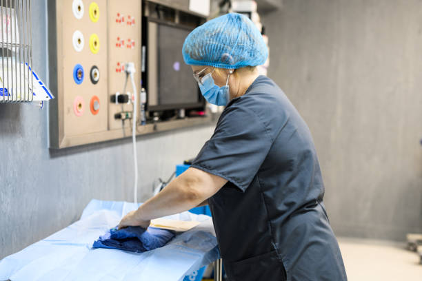 istock Side view doctor unwraps sterile surgical gown 1972424469