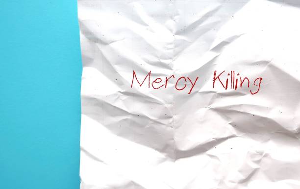 istock Crumpled paper onblue background with text MERCY KILLING, or EUTHANASIA, an act or practice of persons suffering from painful and incurable disease ending life to relieve pain and suffering 1972439453