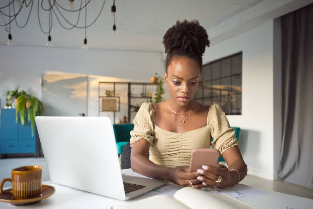 istock Worried woman using smart phone in an office 1972443668
