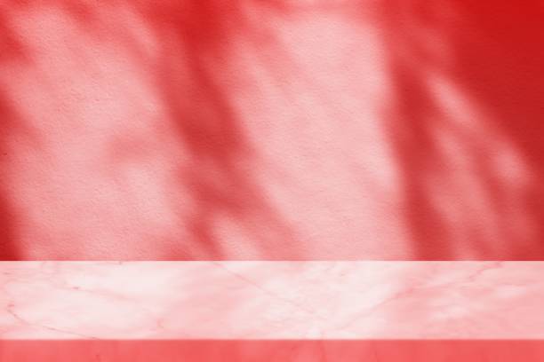 istock White Marble Table with Shadow of willow Leaves on Concrete Wall Texture Background in the Dark Red Tone, Suitable for Product Presentation Backdrop, Display, and Mock up. 1972461411
