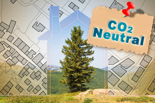 istock CO2 Neutral in construction industry and building activity with home against a natural landscape with lone tree and imaginary city map 1972470552