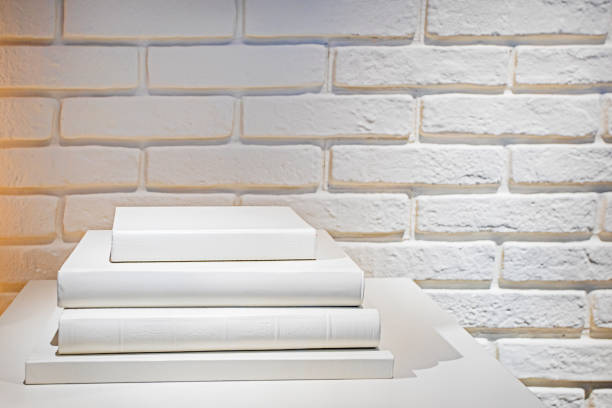 istock stack of white books on a white wall background. Education and 1972482946