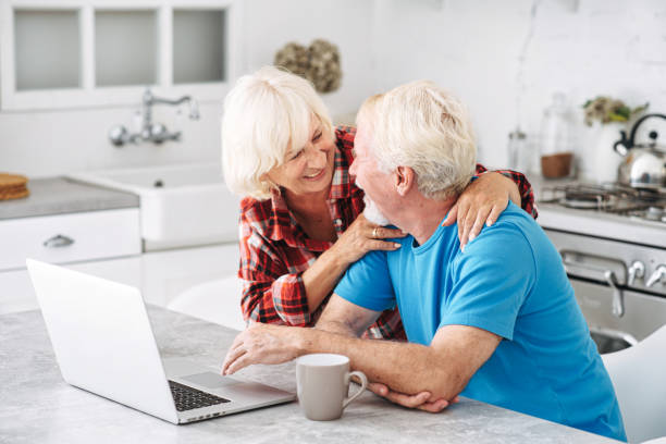 istock Senior couple with laptop at home 1972492113