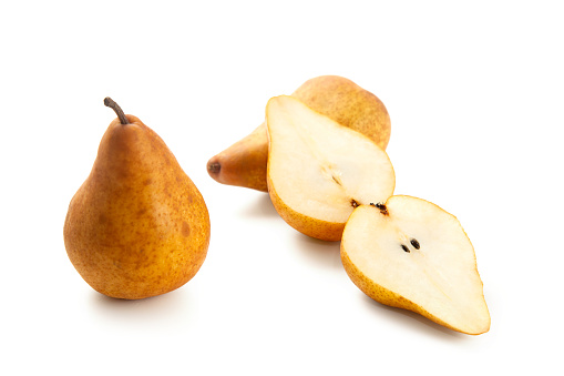 Two whole and halves of ripe juicy pear fruits with soft shadow isolated on white background with clipping path.