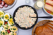 Traditional dishes from Poland for Easter breakfast, visible vegetable salad, top view.