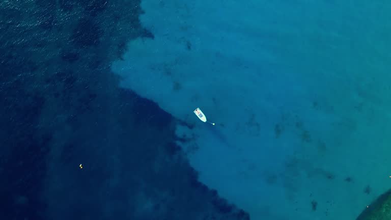 Skyview of a sailboat in Blue Lagoon, Punta Molentis Beach, Villasimius, South Sardinia, Italy