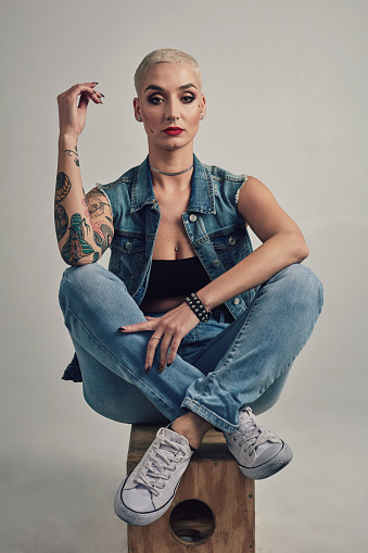 Cube, portrait and woman with tattoo style, alternative culture or casual confidence in studio. Artistic entrepreneur with creative identity, fashion and trendy clothes with pride on grey background