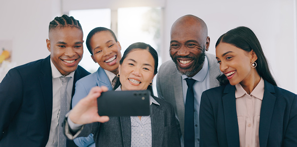 Smile, selfie and happy business people in the office for team building or bonding together. Collaboration, diversity and group of professional work friends taking a picture at modern workplace.