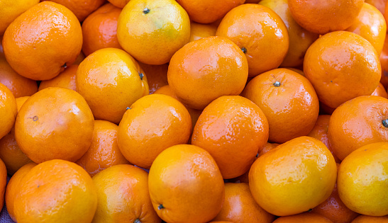 Orange fruit with leaves on a plate on a colored background, Top view. Natural orange with Salt shaker, orange sliced, Orange Farm.