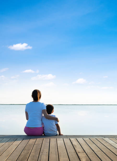 istock Mother and son sitting on the beach 1972532292