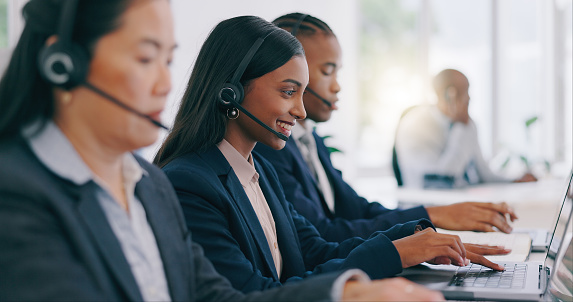 Call center, customer service and an indian woman with a headset in her office for help or assistance. Customer support, contact us or question with a young employee working on a laptop at her desk