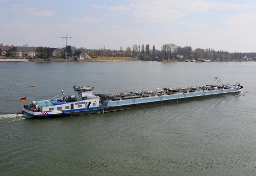 Mainz, Germany-March 28,2015:Long Tanker Ship with German Flag moving on River Rhine