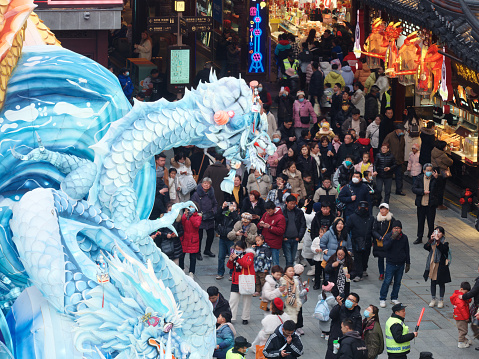 Shanghai, China - Jan. 29, 2024: Lantern Festival in the Chinese New Year( Dragon year), high angle view of Chinese traditional colorful dragon lanterns and crowded tourists in Yuyuan Garden.