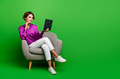 Full body length photo of confident businesswoman touch chin deep thinking hold macbook pro air isolated on green color background