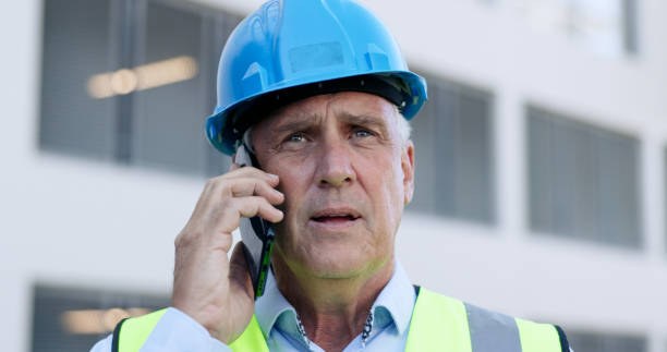 istock Construction, architect and old man, phone call and communication, meeting and contact with contractor. Urban development, project management and engineering, networking for infrastructure outdoor 1972558409
