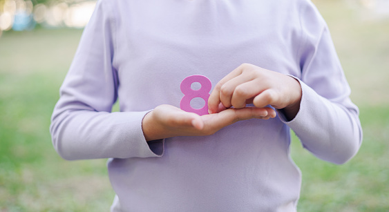 Child Holding Number 8