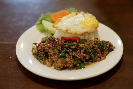 Pad Krapow (rice with stir-fried minced pork and basil leaf and sunny side up) in Thai restaurant