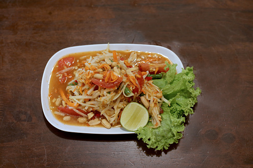 A plate of Som Tam (paw paw or raw papaya salad) in Thai restaurant