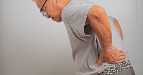 istock An old Asian man has back pain after lifting a heavy object. 1972578964