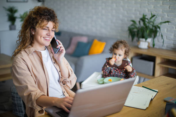 istock Young mother working from home while taking care of her baby 1972599264