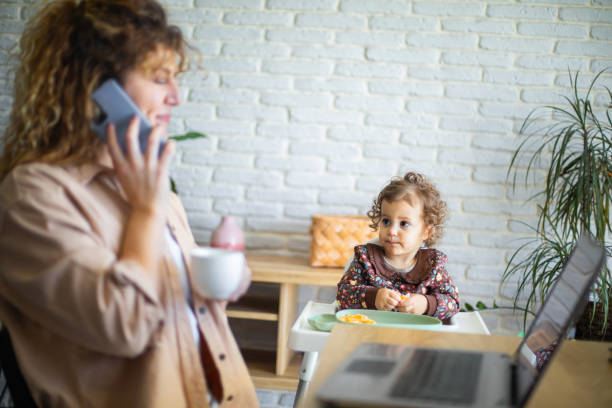 istock Young mother working from home while taking care of her baby 1972601497
