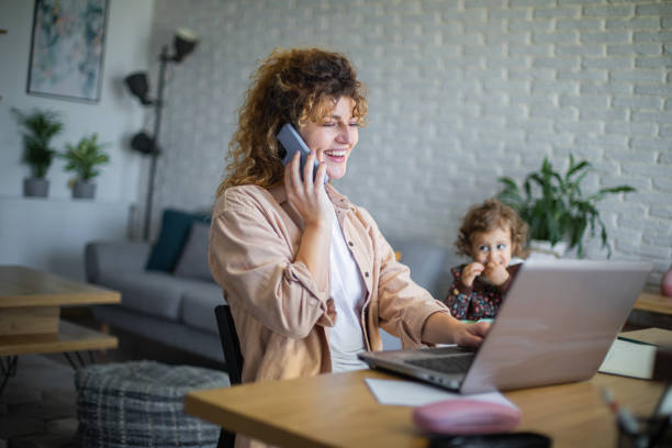 istock Young mother working from home while taking care of her baby 1972607040