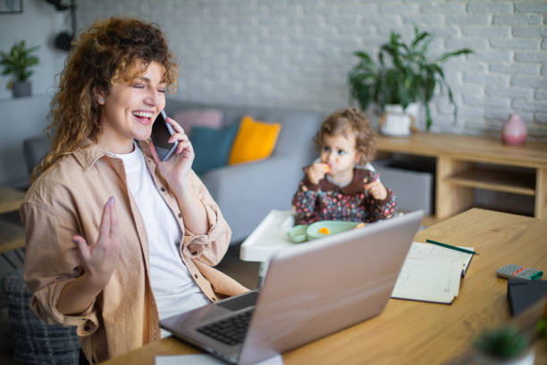 istock Young mother working from home while taking care of her baby 1972608095