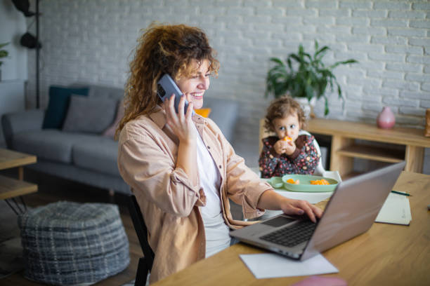 istock Young mother working from home while taking care of her baby 1972608634