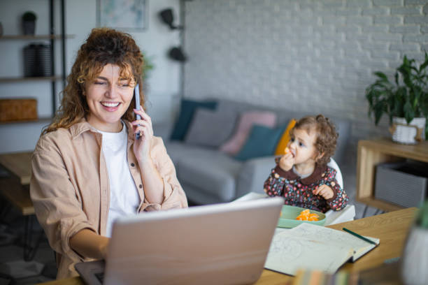 istock Young mother working from home while taking care of her baby 1972610784