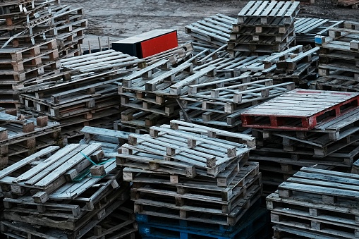 A couple of wooden pallets piled chaotic on a commercial business site