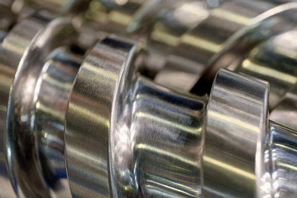 Steel helical conveyer screw, close-up shot, selective focus, abstract industrial background