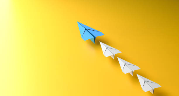 istock Leadership concept, blue leader plane leading white planes, on yellow background 1972619322