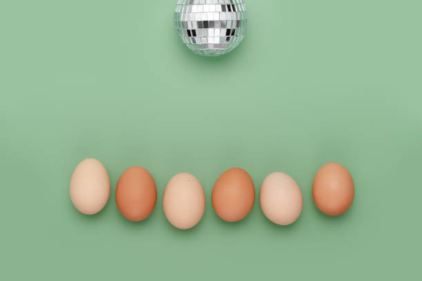 Row of eggs under disco ball. Fun Easter background