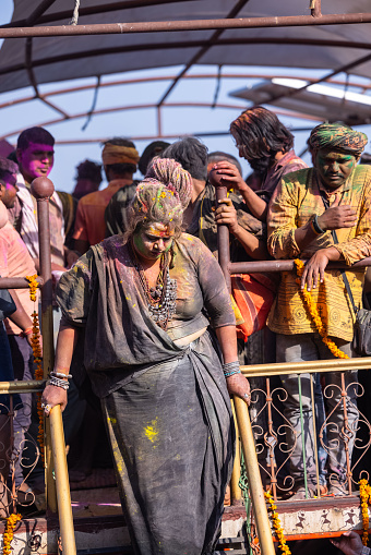 Varanasi, Uttar Pradesh, India - March 2023: Masan holi, Group of unidentified people celebrating the festival of holi at manikarnika ghat with colors and fun.