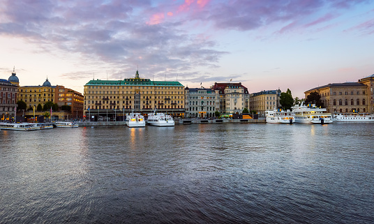 Stockholm, Sweden - July 15, 2023: Cityscape of Stockholm. City streets. Classical architecture. Evening time, soft sunlight, beautiful sky.