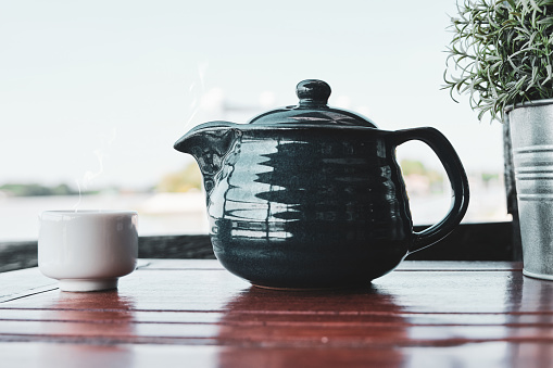 Hot tea on wooden table by the window