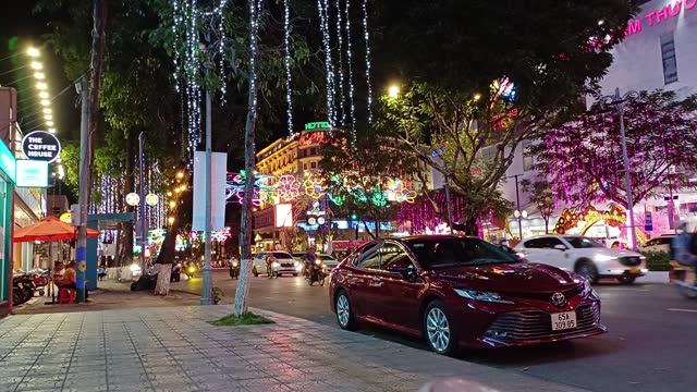 View of nightlife Hoa Binh avenue in Can Tho city, Vietnam. Cityscape with traffic and mall in downtown.