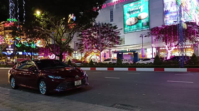 View of nightlife Hoa Binh avenue in Can Tho city, Vietnam. Cityscape with traffic and mall in downtown.