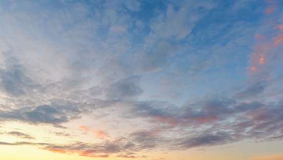 Dramatic blue, pink and orange sunset with fantasy clouds.