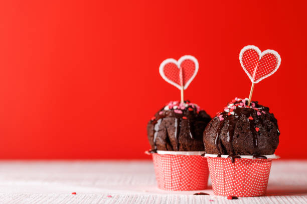 istock Cupcake love: Heart-themed treats on a vibrant red backdrop 1972684737