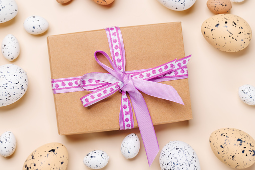 Easter delights: Colorful eggs in a festive arrangement and gift box. Flat lay