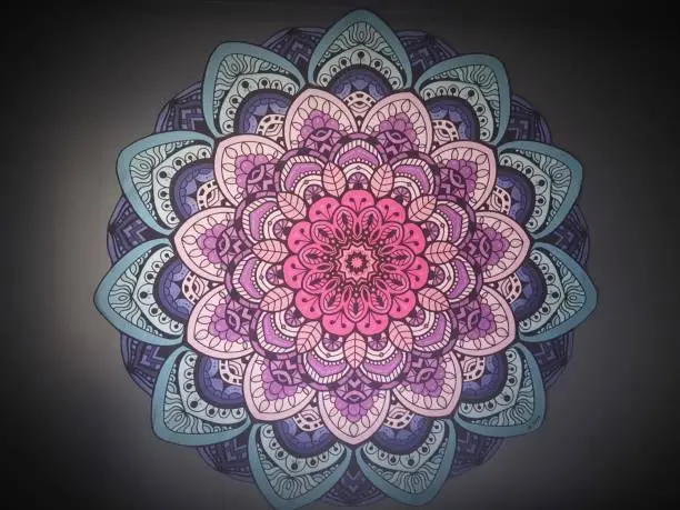 Beautiful colorful mandala on a dark gray background. Front view.