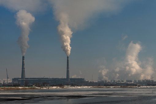 Smoking chimneys of a coal-fired power plant on a winter day