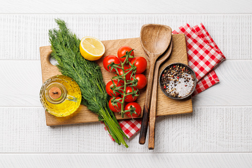 Cooking scene: Cherry tomatoes, herbs and spices on table. Flat lay