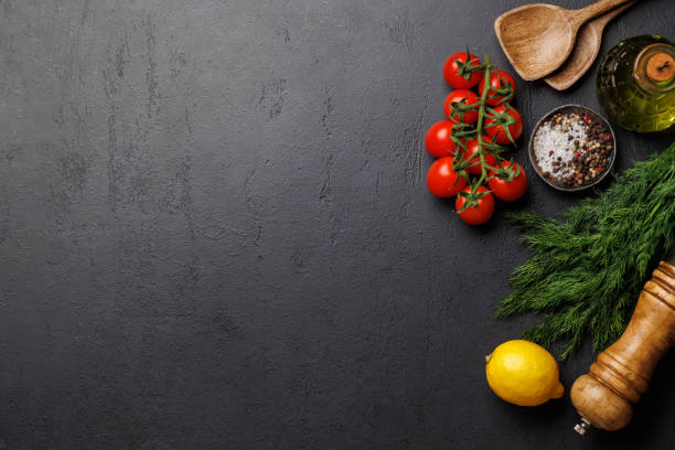 istock Cooking scene: Cherry tomatoes, herbs and spices on table 1972701716