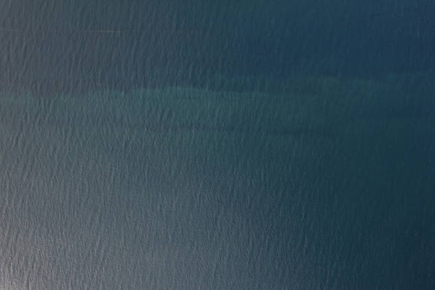 Texture of blue shallow sea water above top drone view