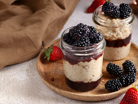 dessert in a jar with jam and fresh berries