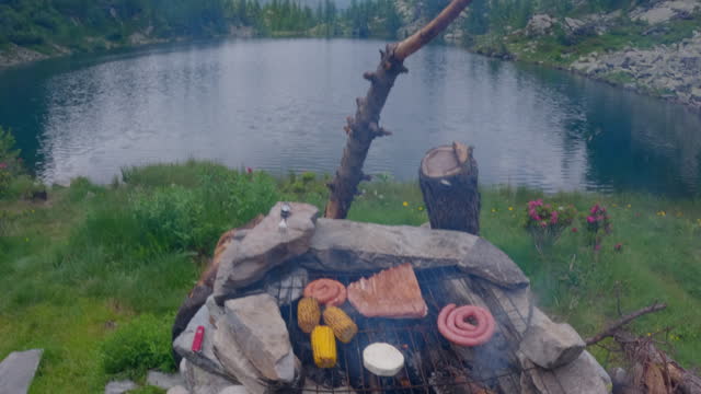 Wild camping and hiking in the Alps, having a bbq in nature