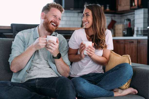 istock Lovely young couple drinking coffee at home. 1972727886